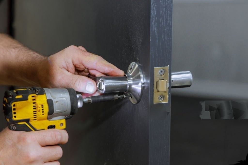 Locksmith Carleton Place repairing a door lock showing only a hand.
